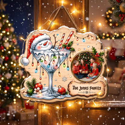 Shop custom Christmas wooden signs! Durable 0.5cm plywood cutout featuring a snowman in a cocktail glass, Christmas lights, custom family photo & personalized plaque!