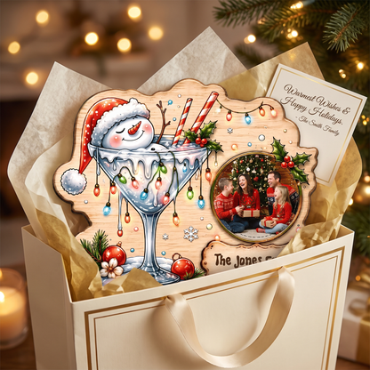 Shop custom Christmas wooden signs! Durable 0.5cm plywood cutout featuring a snowman in a cocktail glass, Christmas lights, custom family photo & personalized plaque!