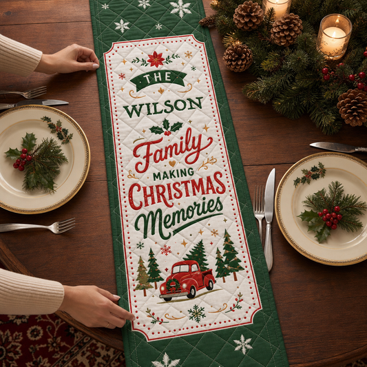 Hands placing a green bordered quilt runner reading custom family name Making Christmas Memories with vintage red truck and trees