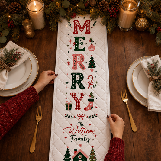 Hands placing a white quilt runner with vertical MERRY letters in red, pink and green, holiday icons and custom family name
