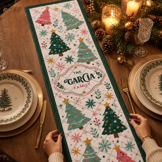 Hands placing a white quilt runner with whimsical pink, mint and green Christmas trees, snowflakes and custom family name label