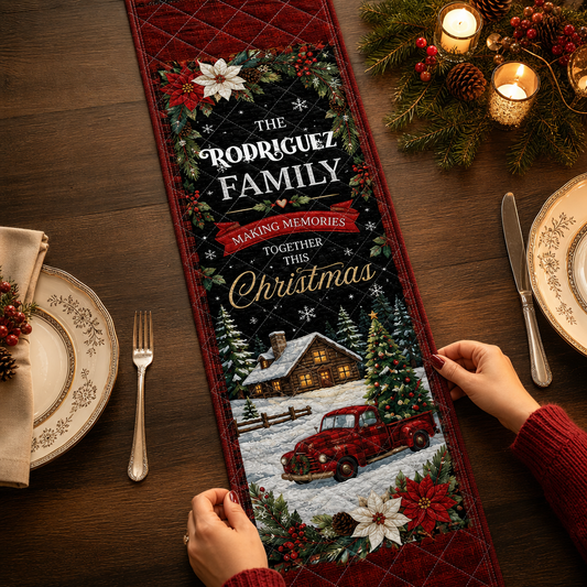 Hands holding a red plaid bordered quilt runner with family name, Making Memories Together This Christmas, cabin and red truck