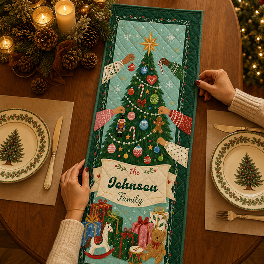 Hands placing a teal quilt runner of many hands decorating a Christmas tree with toys, gifts and custom family name banner