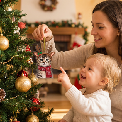 Mother hanging the reindeer cat ornament as a toddler points and smiles