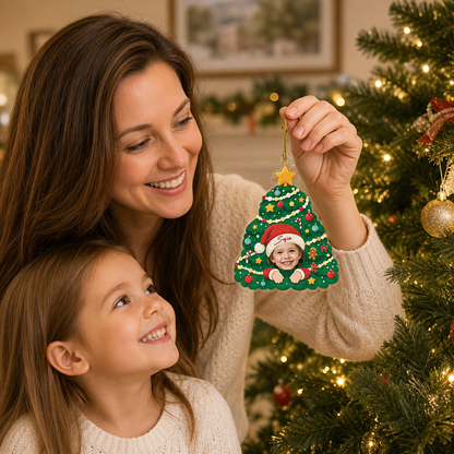 Mother hanging the custom Christmas tree photo ornament as her daughter smiles
