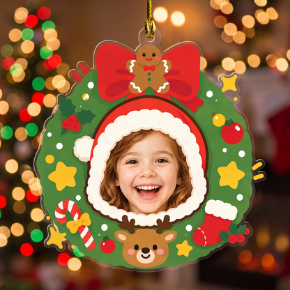 Santa hat wreath photo ornament with a smiling girl's face in front of colorful bokeh lights
