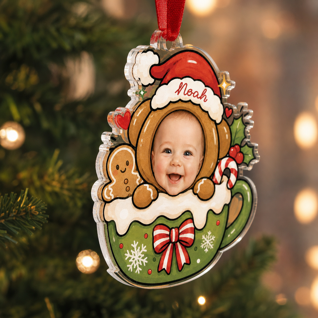 Side view of the clear acrylic gingerbread bear cocoa mug ornament on a red ribbon