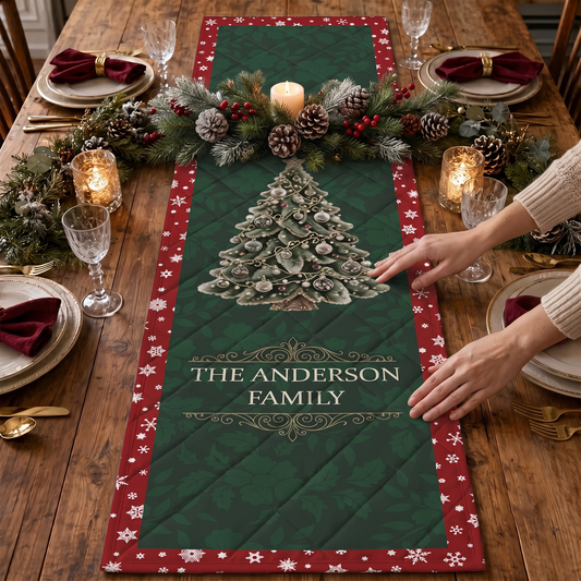 Hands placing a green damask quilt runner with a silver frosted Christmas tree, custom family name and red snowflake border