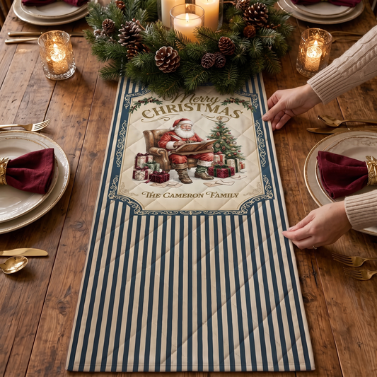 Hands placing a navy and cream striped quilt runner with a vintage Merry Christmas Santa reading by a tree panel and custom family name