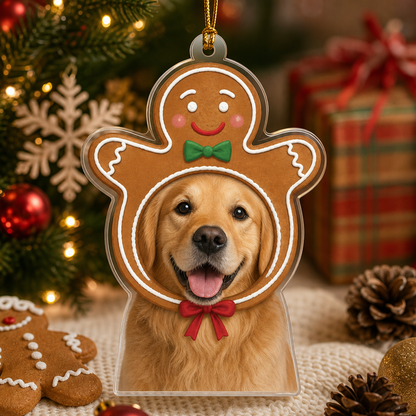 Gingerbread man pet ornament with a golden retriever photo beside gingerbread cookies and pinecones