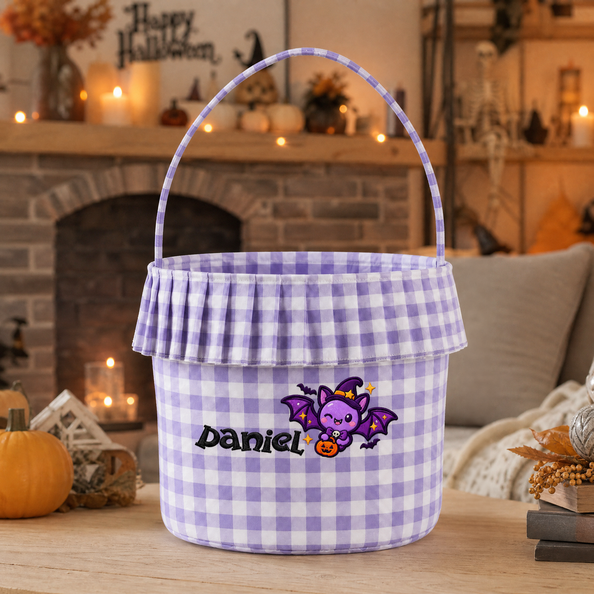 Purple gingham ruffle basket embroidered with a purple bat in a witch hat and custom name by a stone fireplace