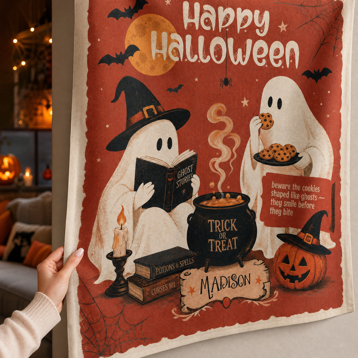 Hand holding the corner of the red ghost cookie tapestry to show the fabric and custom name banner