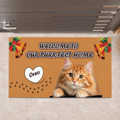 Orange doormat reading Welcome to Our Purr-fect Home with a custom orange tabby cat photo, a heart name tag, bells and paw prints