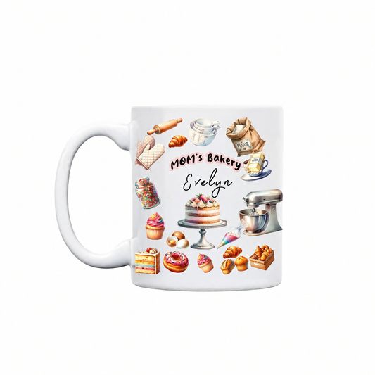 White ceramic MOM's Bakery mug with cakes, cupcakes, donuts, stand mixer and rolling pin around a custom name