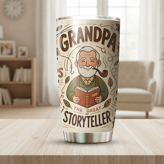 Cream Grandpa The Great Storyteller 20oz tumbler with pipe smoking grandpa reading a red book on a wooden table