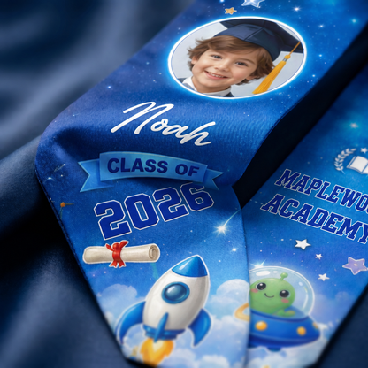 Close-up of the blue galaxy rocket kid graduation stole showing child photo, Noah, Class of 2026 and Maplewood Academy