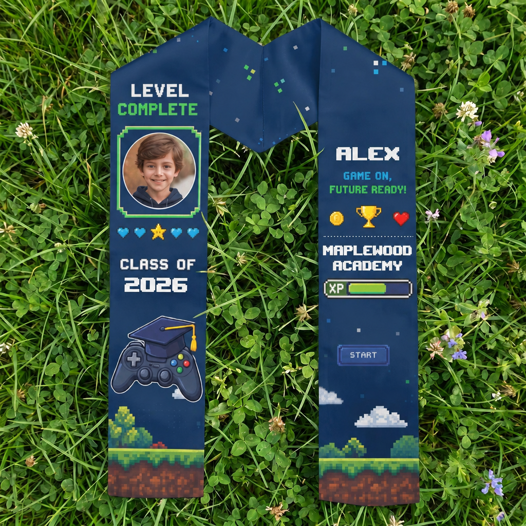 Navy video game kid graduation stole with child photo, Level Complete, name Alex, Class of 2026 and Maplewood Academy laid on grass