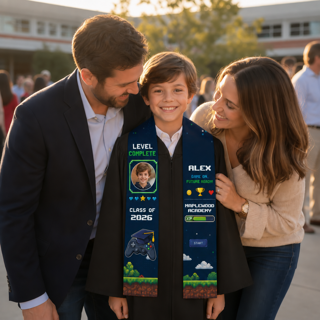 Smiling boy with parents wearing the Level Complete game photo stole reading Alex and Maplewood Academy