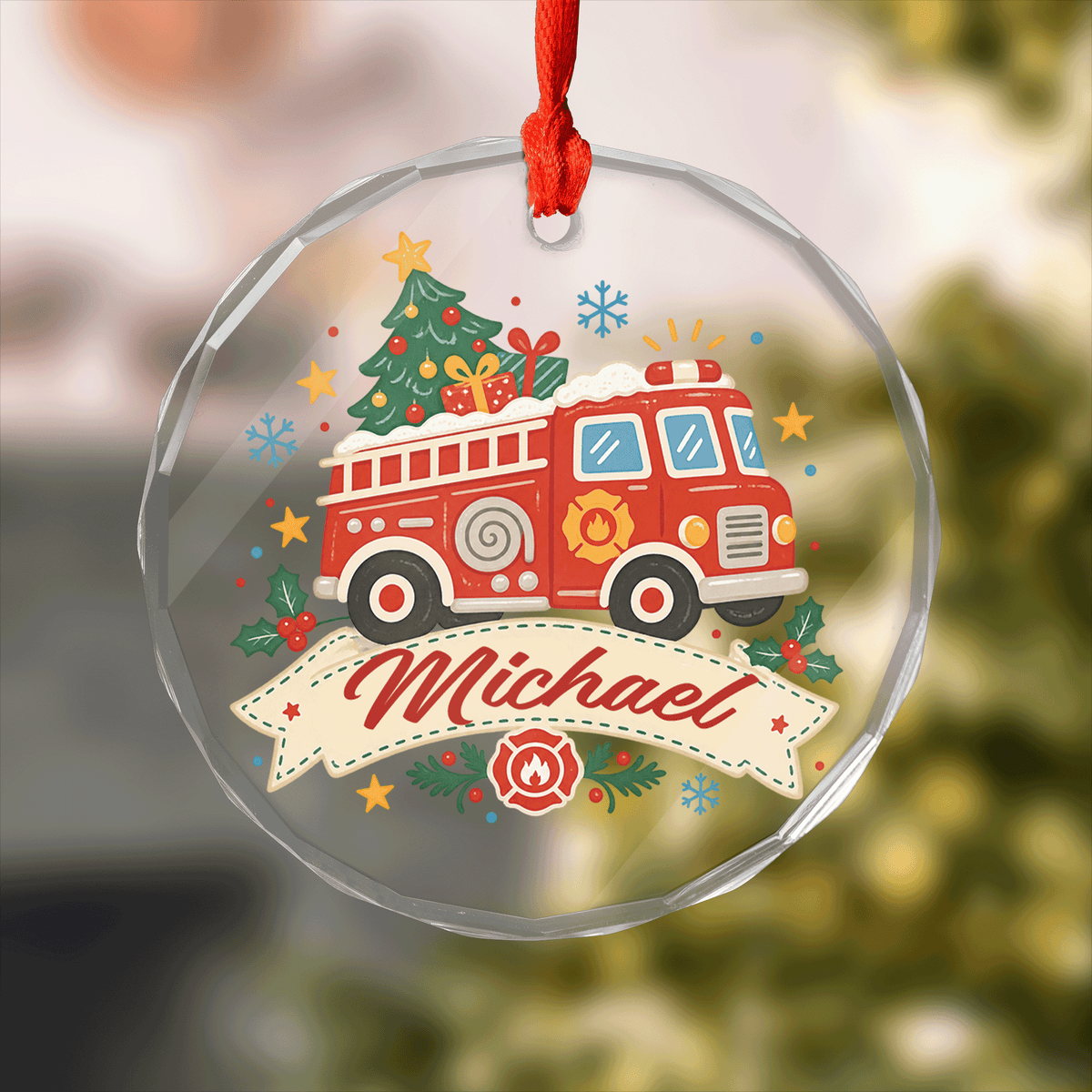 Round clear glass ornament with a fire truck carrying a Christmas tree and gifts and a custom name banner