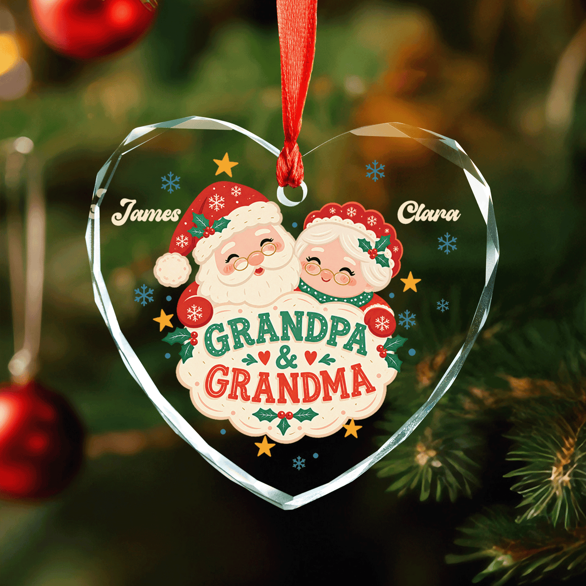 Heart shaped clear glass ornament with a Santa couple, Grandpa and Grandma sign and two custom names