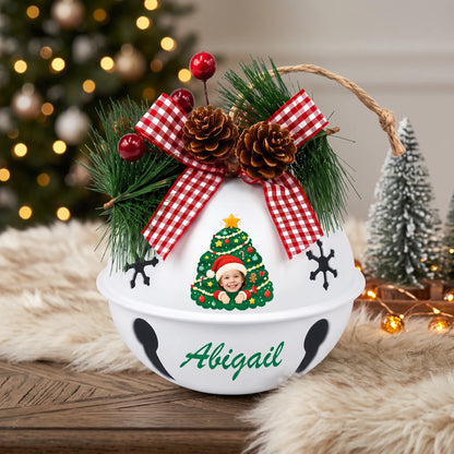 Personalized kid photo jingle bell ornament with name on a festive table