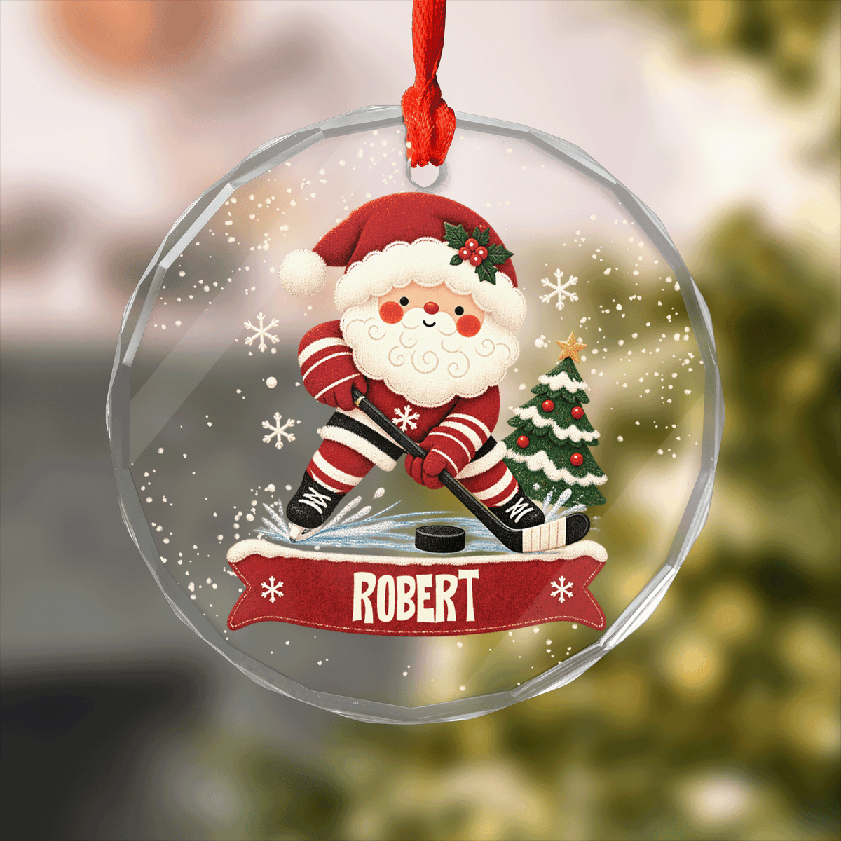 Round clear glass ornament with Santa playing hockey on ice, a snowy tree and a custom name banner