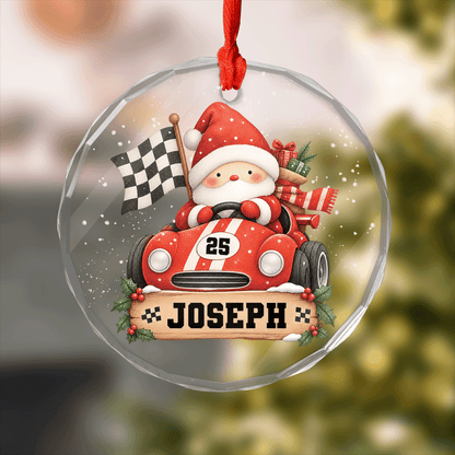 Round clear glass ornament with Santa driving a race car, checkered flag, racing number and a custom name