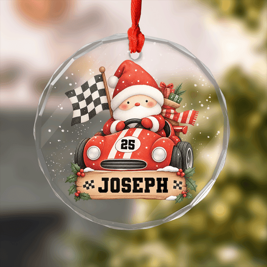 Round clear glass ornament with Santa driving a race car, checkered flag, racing number and a custom name