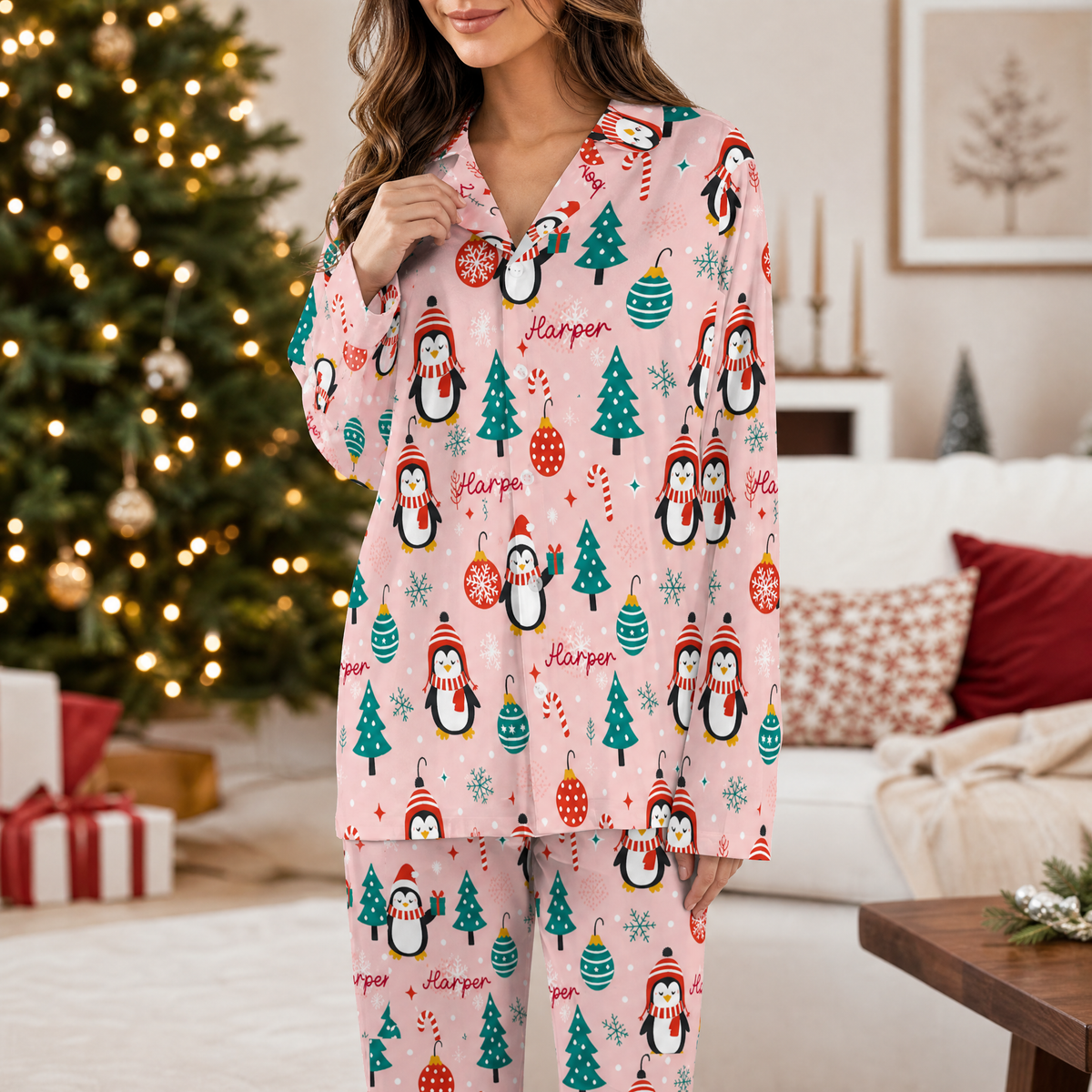 Woman wearing custom name penguin snowflake tree Christmas pajamas by the tree