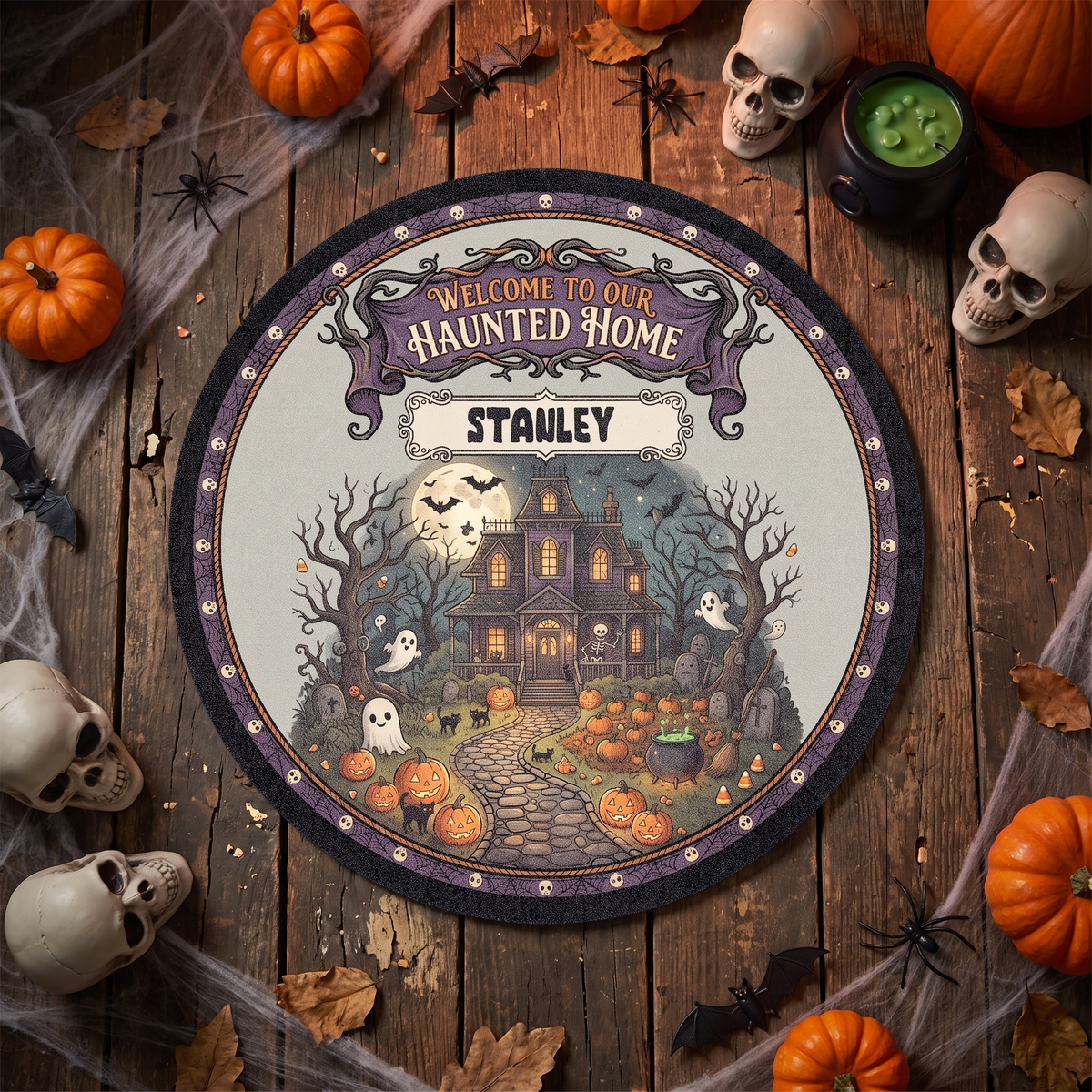 Personalized Halloween Welcome To Our Haunted Home Moonlit Manor Round Rug with custom name, styled on a wood floor with pumpkins