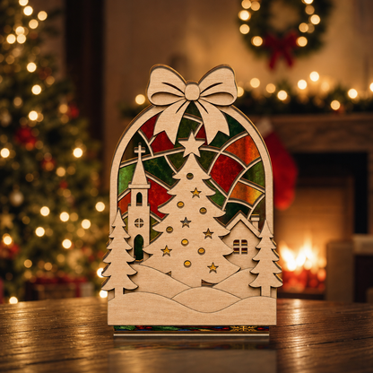 Christmas bow village suncatcher candle holder glowing on holiday table