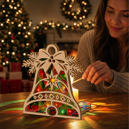 Christmas bell suncatcher candle holder glowing on holiday table