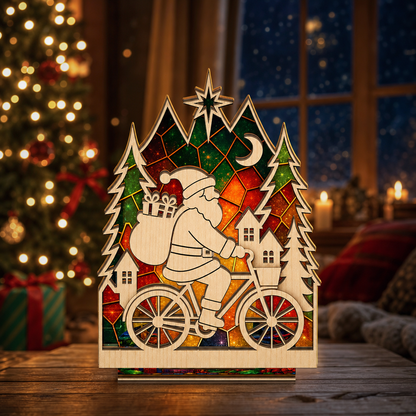 Christmas Santa bicycle suncatcher candle holder glowing on holiday table