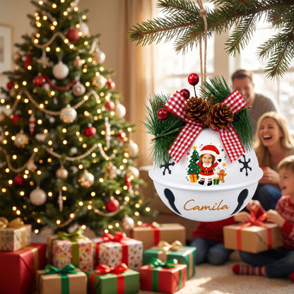 Personalized Santa kid jingle bell ornament hanging by the Christmas tree with family opening gifts