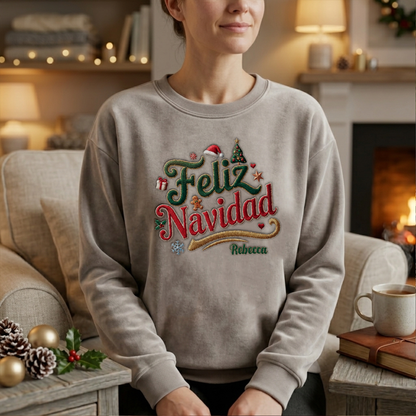 Woman wearing the heather grey Feliz Navidad embroidered sweatshirt with custom name by a cozy fireplace