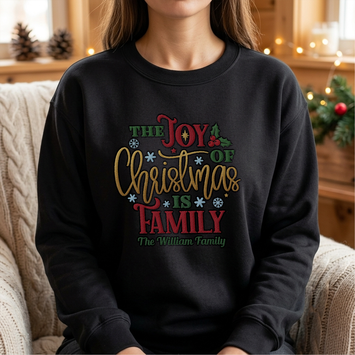 Woman wearing the black The Joy of Christmas Is Family embroidered sweatshirt with custom family name
